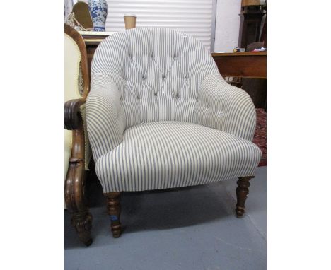 A modern button upholstered armchair, raised on turned, tapered, stained beech legs