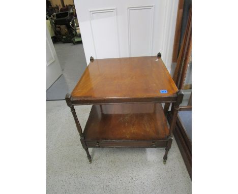 A reproduction mahogany, two tier lamp table with base drawer on turned legs and brass castors, 23 6/8 x 21 6/8 x 22