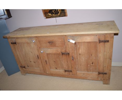 A 20th Century pine sideboard, fitted a single drawer to the frieze, and three cupboard doors fitted blue and white ceramic h