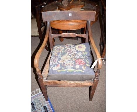 A Regency rustic carver chair, the square tapering legs joined by stretchers, with woolwork tapestry cushion.