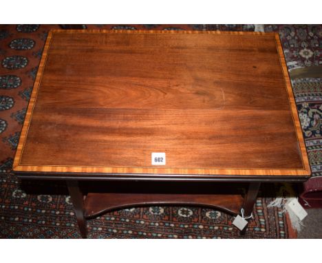 An Edwardian inlaid mahogany swivel action turnover top card table, inset with green baize and green gilt leather, the legs j