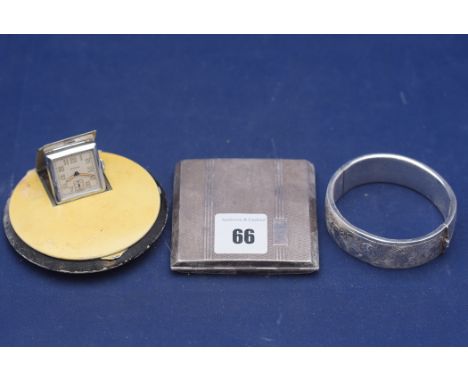 A George VI silver compact mirror, by William Adams Ltd., Birmingham 1947, with engine turned decoration; an engraved silver 