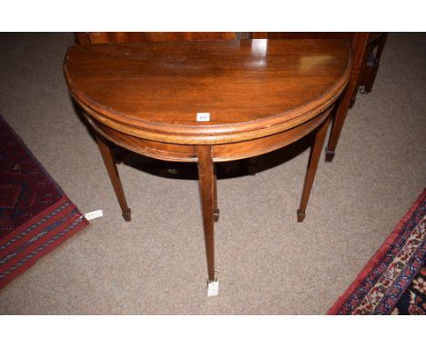 A reproduction mahogany D-shaped turnover top card table, raised on square tapering legs, 77cms wide.