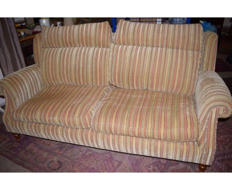 A Parker Knoll two seater sofa, upholstered in striped material, raised on turned front legs.