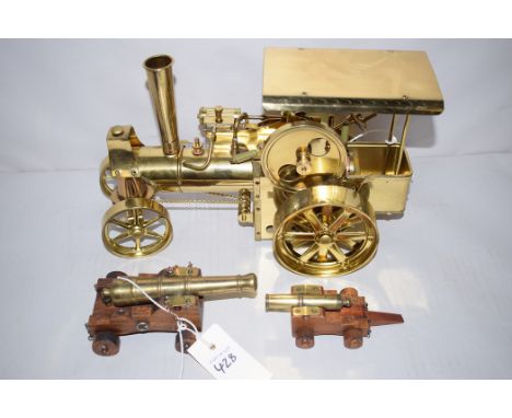 A West German brass model of a steam engine, probably by Wilesco; and two brass miniature models of canons, one with initials