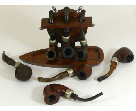 Seven Irish Peterson pipes and a nautical three pipe stand 