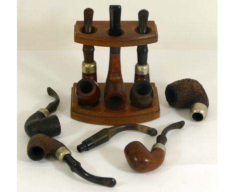 Seven Irish Peterson pipes and a three pipe stand 