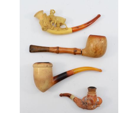 A carved Meerschaum pipe of a mountain goat, another of a claw and two plain examples