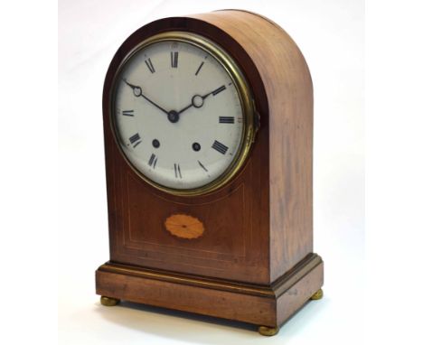 Early 20th century mahogany and boxwood lined inlaid mantel clock, the plain arched case on a plinth base and raised on compr