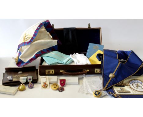 Small case containing assortment of Masonic memorabilia and ephemera including books on the constitution, various aprons, tie