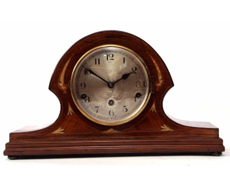 Mid-20th century mahogany and boxwood line inlaid triple barrel mantel clock, the arched and waisted case to a spun brass bez