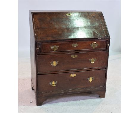 A GEORGE III OAK BUREAUWith three long graduated drawers on bracket feet 86cm wide; 103cm high