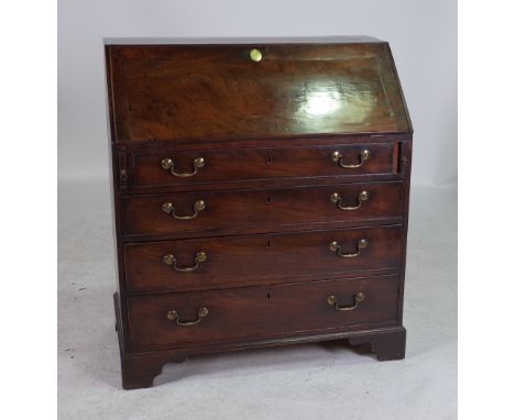 A GEORGE III OAK BUREAUWith four long graduated drawers on bracket feet 91cm wide; 104cm high