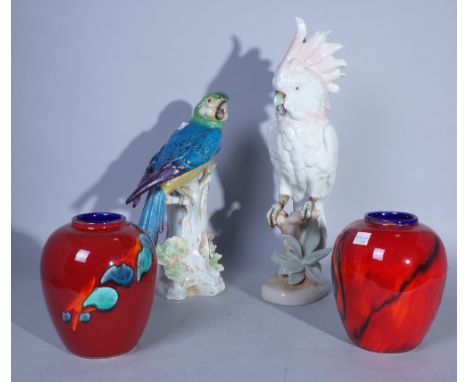 CERAMICS TO INCLUDE A PAIR OF POOLE VASES, AND TWO CONTINENTAL CERAMIC FIGURES OF BIRDS (4)The tallest 42cm high