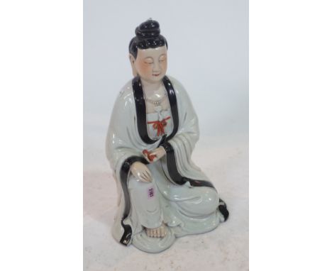 A LARGE CHINESE PORCELAIN FIGURE OF GUANYINProbably late 20th centuryModelled seated holding an iron-red scroll in her left h