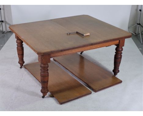 A VICTORIAN OAK EXTENDING DINING TABLEWith two extra leaves on ring turned supports 144cm long; 121cm wide; 242cm fully exten