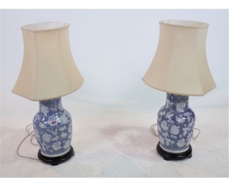 A PAIR OF MODERN BLUE AND WHITE CERAMIC TABLE LAMPS40cm highGood over all condition no chips or cracks top the body of the va