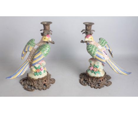 A PAIR OF MODERN ITALIAN STYLE GILT METAL MOUNTED CERAMIC CANDLE STICKSThe bases formed as parrots each 29cm highBoth in good