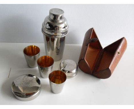 A vintage silver plated cocktail shaker in leather case with three beakers/tots and lid strainer, 13.5 cm H 