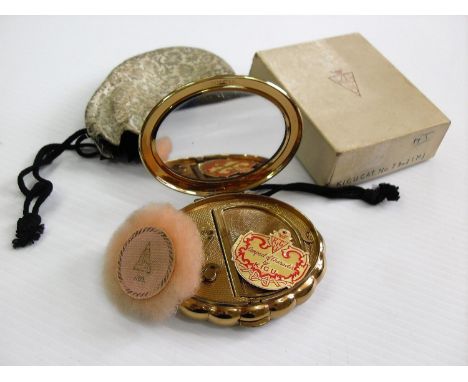 A KIGU 1950's brass-cased musical 'Minuette' compact with original packaging, unused condition 