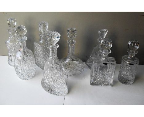 An assortment of eight cut-glass crystal decanter, all with original stoppers to include two by Thomas Webb and a boxed silve
