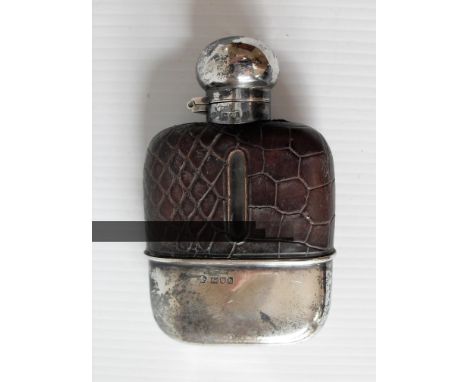 An Edwardian glass and silver hip flask, hinged cap and leather cover by William Hutton & Sons, London 1904 