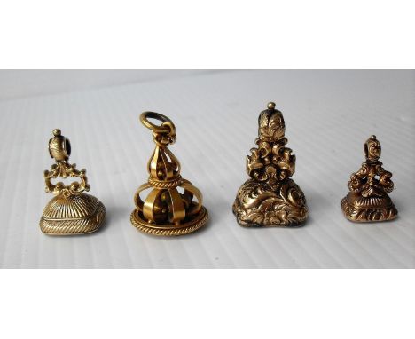 Four highly ornate Victorian yellow metal fob seals: a carved and monogrammed amethyst, two citrines and an oval Carnelian in
