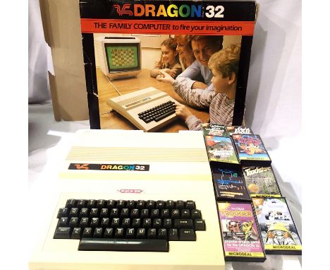 Dragon 32 computer with cover, box and eight game cassettes. P&P Group 1 (£14+VAT for the first lot and £1+VAT for subsequent