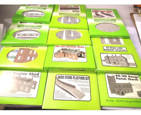 Eleven Metcalfe card building OO scale kits; church, platform x2, retaining wall x2, engine shed x2, railway bridge x2, stati