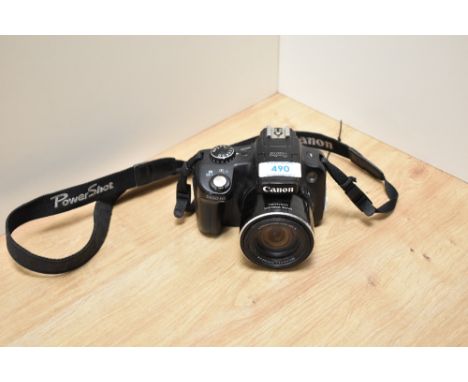 A Canon SX50 HS digiral camera with Canon zoom lens 50x15 4.3-215mm  1:3,5-6,5. No battery or charger