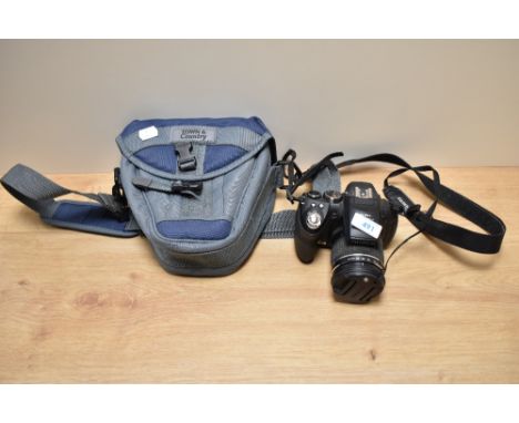 A Fujifilm Finepix digital camera with Fujinon 30x f:4,2-126 1:2,8-5,6 lens