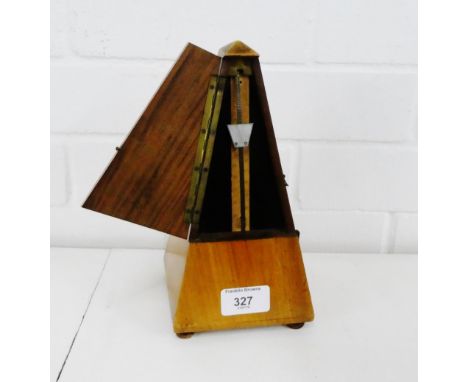 A Maelzel metronome on four bun feet