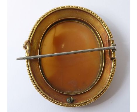 A mid 19th century cameo, yellow gold and enamel brooch, the oval shell cameo depicting the head and shoulders of female warr