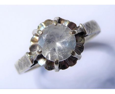 A white stone ring, the circular-cut stone coronet-set above the textured shoulders and plain shank stamped '14k', size K½ (3