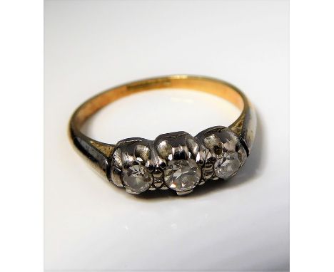 A three stone brilliant-cut diamond ring to the plain shank stamped '18CT PLAT', size J (gross weight 2.1g)