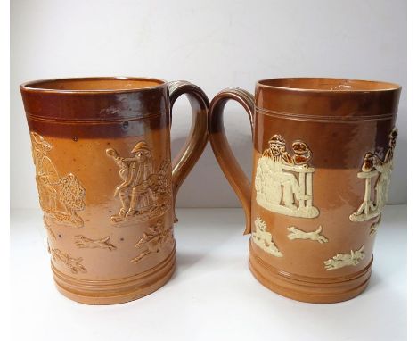 Two similar 19th century salt glaze Doulton Lambeth tankards; typically decorated in relief with hunting and tavern scenes et