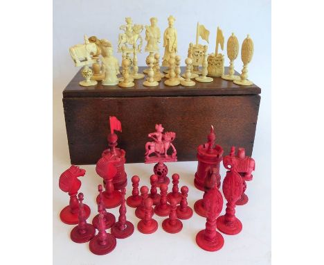 A good selection of late 19th century carved and set stained ivory chess pieces to include seven white pawns, four larger whi