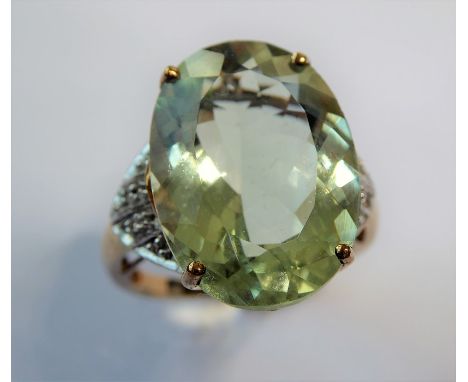 A pale green (probably beryl) ring, the oval mixed-cut stone claw-set to the 9 carat yellow and white gold setting, Birmingha