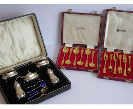 An early 20th century cased five-piece hallmarked silver cruet set comprising two salts with blue-glass liners, two pepperett