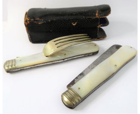 A black leather cased campaign-style folding knife and fork set; each with mother-of-pearl handle and rectangular vacant cart