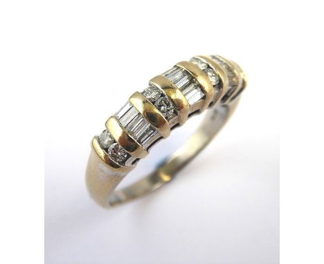 A diamond-set half hoop ring, the top section with three baguette-cut diamond-set arches, each separated by a pair of brillia