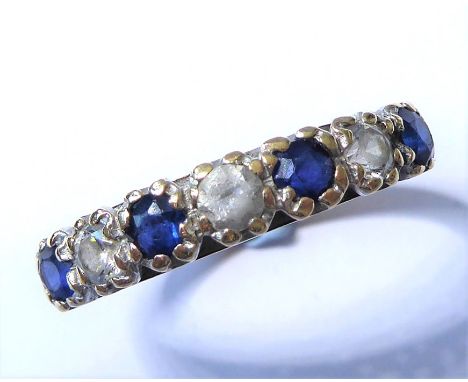 A sapphire and white sapphire half hoop ring, the four circular-cut sapphires each separated by a white sapphire to the taper