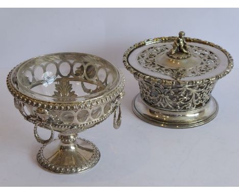 A cut-glass bowl within an ornate silver-plated mount headed with four female mask and ring heads above acanthus leaves and a