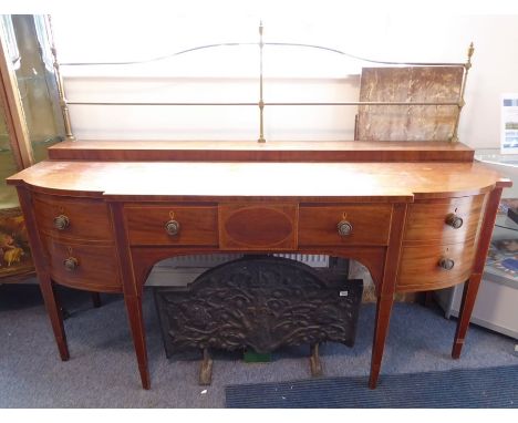 A late 18th/early 19th century mahogany and boxwood-strung serving sideboard of large proportions; the brass gallery headed w