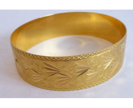 A bangle, decorated with foliate and matt engraving, foreign control mark, (with insurance valuation stating the bangle has b