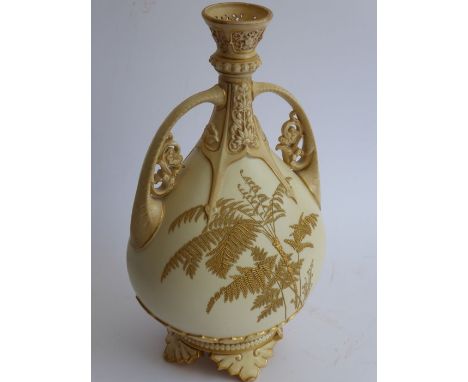 A late 19th century Worcester blush porcelain vase; flaring reticulated top above two ornate handles and the front and revers