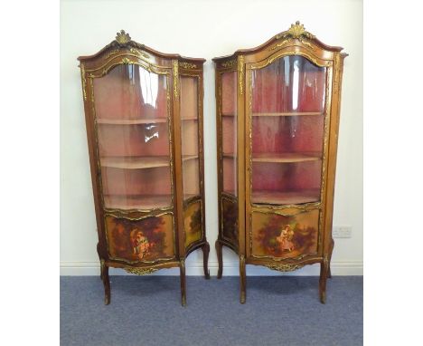 A good pair of late 19th / early 20th century Louis-XV-style walnut vitrines: gilt-metal-mounted and serpentine-fronted; cent