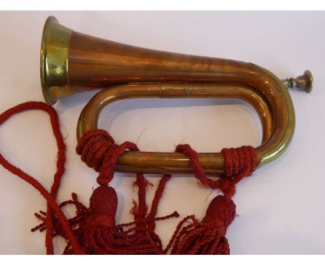 A brass mounted copper bugle; signed 'Barratts, England', together red rope tassels and detachable silvered mouthpiece (29cm 