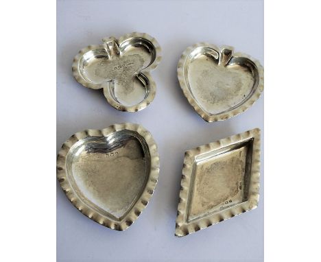 A set of four small hallmarked silver trinket dishes; modelled as playing card suits (clubs, diamonds, spades and hearts); ea