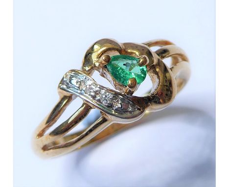 An emerald and diamond-set ring, the pear-shaped emerald claw-set above an openwork setting with single-cut diamond detail, t